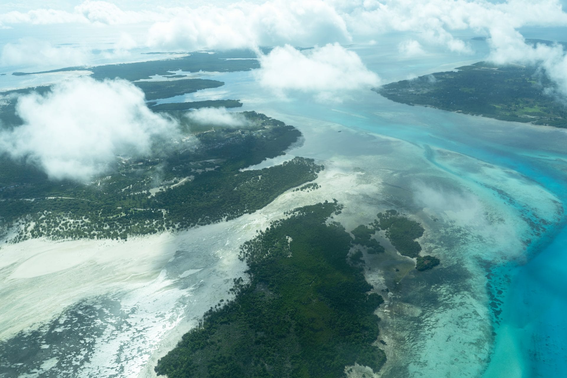 Aerial photo of tree covered islands surrounded by blue ocean