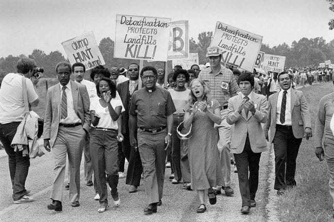 Black and white image of protesters holding signs